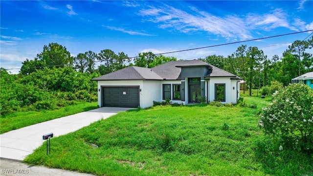 739 David Laird Ln, Lehigh Acres, FL 33974 - view of front of home with driveway, stucco siding, a garage, and a front lawn