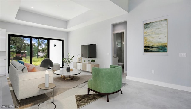 739 David Laird Ln, Lehigh Acres, FL 33974 - living area featuring finished concrete floors, a tray ceiling, and recessed lighting