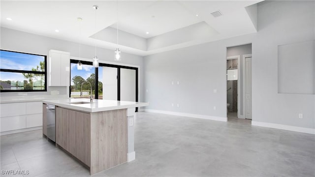 766 Naples Ave S, Lehigh Acres, FL 33974 - kitchen featuring modern cabinets, dishwasher, light countertops, a raised ceiling, and pendant lighting