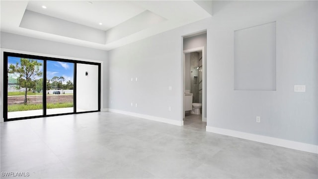 766 Naples Ave S, Lehigh Acres, FL 33974 - empty room featuring finished concrete flooring and a tray ceiling