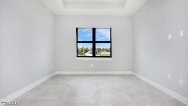 766 Naples Ave S, Lehigh Acres, FL 33974 - spare room with concrete flooring and a tray ceiling
