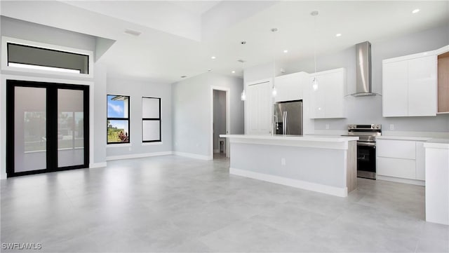 766 Naples Ave S, Lehigh Acres, FL 33974 - kitchen with wall chimney exhaust hood, appliances with stainless steel finishes, modern cabinets, white cabinets, and recessed lighting