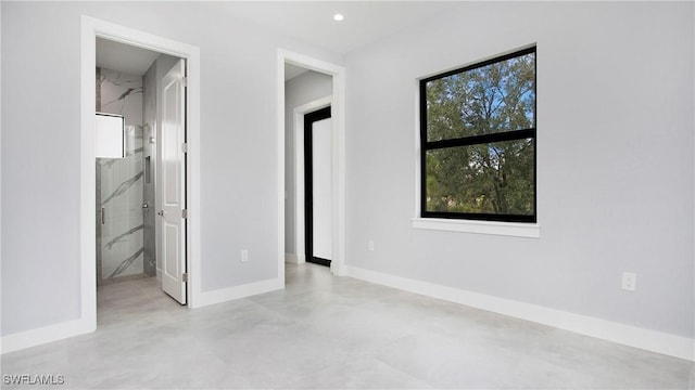 766 Naples Ave S, Lehigh Acres, FL 33974 - unfurnished bedroom with finished concrete floors and recessed lighting