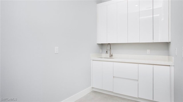 766 Naples Ave S, Lehigh Acres, FL 33974 - bar area with a sink and baseboards