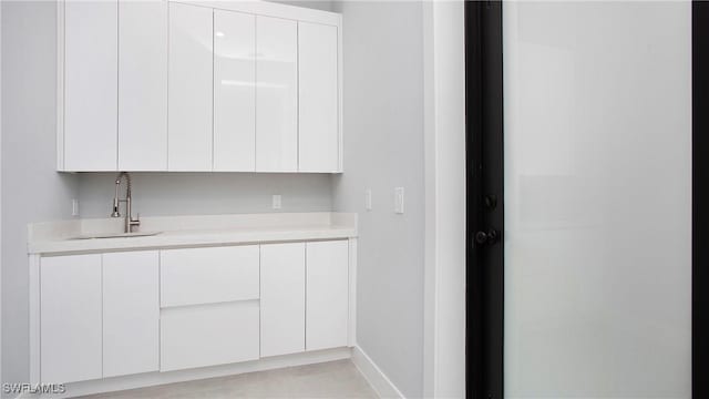 766 Naples Ave S, Lehigh Acres, FL 33974 - kitchen with modern cabinets, light countertops, and white cabinetry