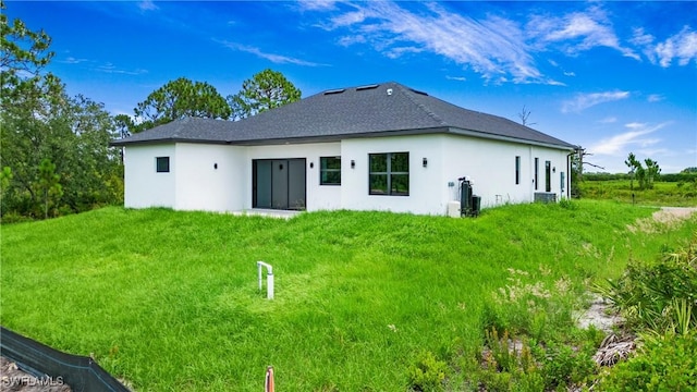 766 Naples Ave S, Lehigh Acres, FL 33974 - rear view of property with stucco siding and a yard