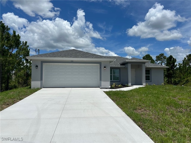 700 Avondale St E, Lehigh Acres, FL 33974 - view of front of home with driveway, stucco siding, a garage, and a front yard