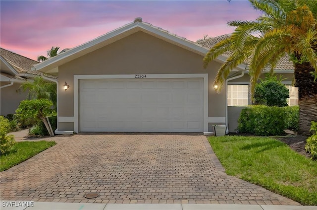 23204 Coconut Shores Dr, Estero, FL 34134 - ranch-style home with stucco siding, driveway, and an attached garage