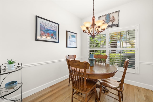 23204 Coconut Shores Dr, Estero, FL 34134 - dining area featuring light wood-type flooring and a chandelier