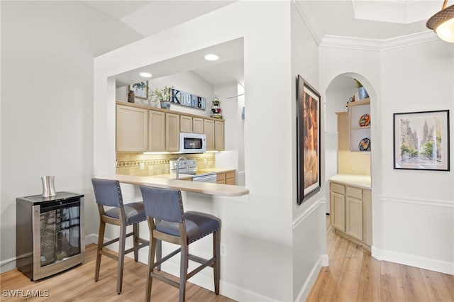 23204 Coconut Shores Dr, Estero, FL 34134 - kitchen featuring white appliances, beverage cooler, light countertops, light wood-style flooring, and tasteful backsplash