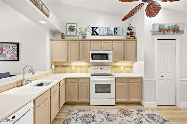 23204 Coconut Shores Dr, Estero, FL 34134 - kitchen with white appliances, light brown cabinetry, light wood finished floors, vaulted ceiling, and tasteful backsplash