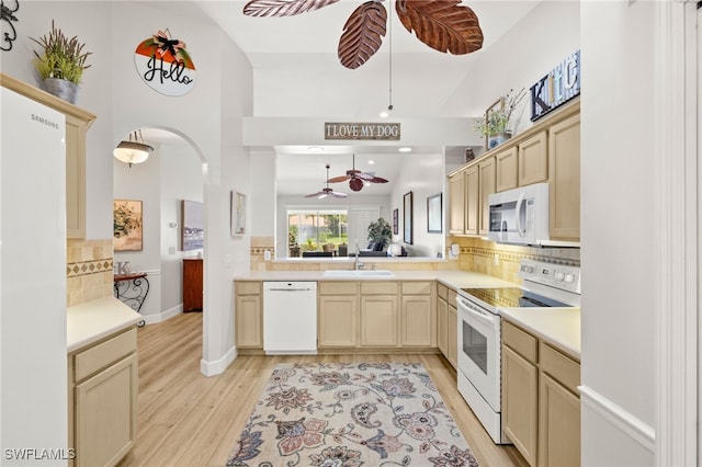 23204 Coconut Shores Dr, Estero, FL 34134 - kitchen featuring white appliances, a ceiling fan, tasteful backsplash, light wood-style floors, and light countertops
