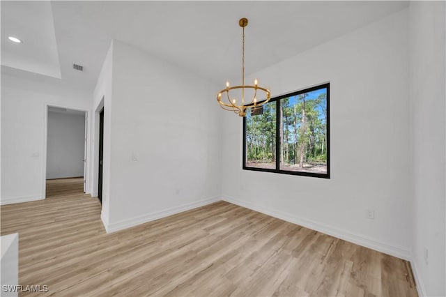 1517 Washington Ave, Lehigh Acres, FL 33972 - spare room featuring a chandelier, light wood-style floors, and recessed lighting