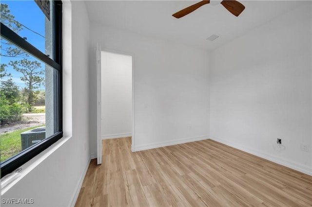 1517 Washington Ave, Lehigh Acres, FL 33972 - empty room with light wood-style flooring and a ceiling fan