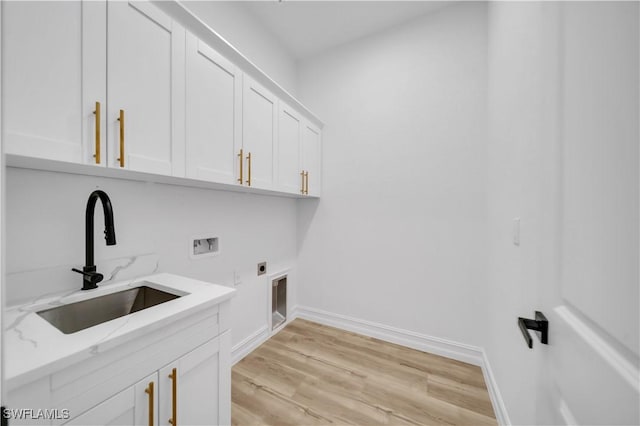 1517 Washington Ave, Lehigh Acres, FL 33972 - washroom with hookup for an electric dryer, washer hookup, cabinet space, and light wood-style floors