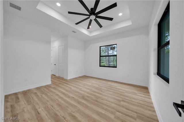1517 Washington Ave, Lehigh Acres, FL 33972 - spare room with a raised ceiling, light wood-style floors, a ceiling fan, and recessed lighting