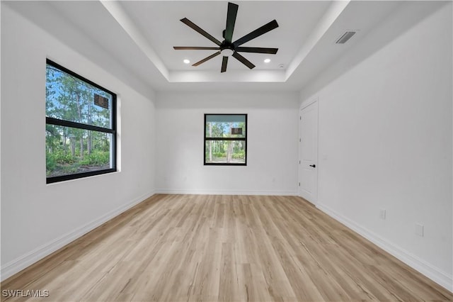 1517 Washington Ave, Lehigh Acres, FL 33972 - empty room with light wood-style flooring, a tray ceiling, a ceiling fan, and recessed lighting
