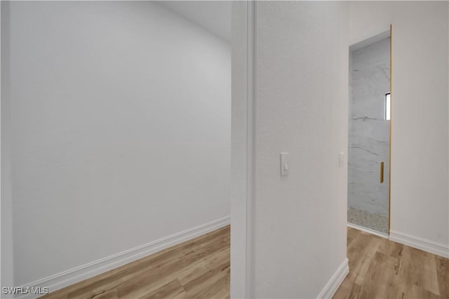 1517 Washington Ave, Lehigh Acres, FL 33972 - hallway featuring light wood-type flooring and baseboards