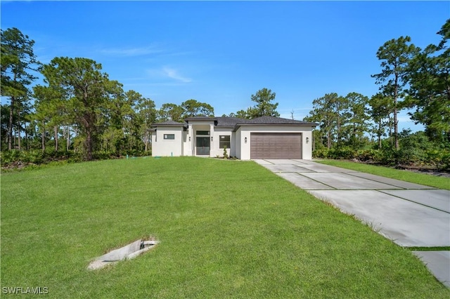 1517 Washington Ave, Lehigh Acres, FL 33972 - prairie-style house with driveway, an attached garage, stucco siding, and a front lawn
