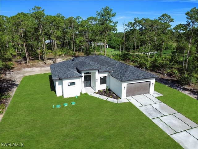 1517 Washington Ave, Lehigh Acres, FL 33972 - view of front facade with driveway, a front yard, an attached garage, and stucco siding
