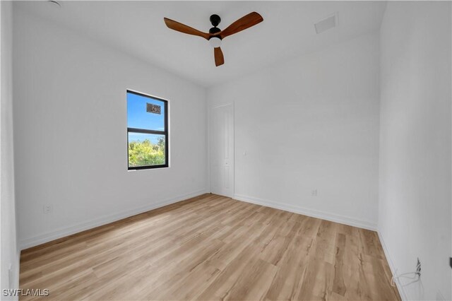 1517 Washington Ave, Lehigh Acres, FL 33972 - unfurnished room featuring light wood-style flooring and a ceiling fan