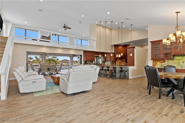 1701 Casey Key Dr, Punta Gorda, FL 33950 - living room featuring a chandelier, a high ceiling, light wood finished floors, and a ceiling fan