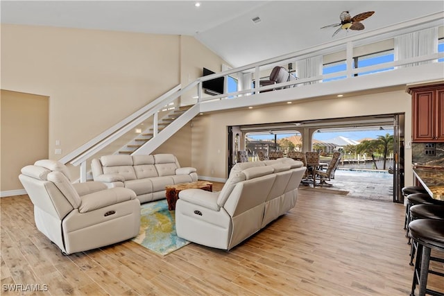 1701 Casey Key Dr, Punta Gorda, FL 33950 - living room with high vaulted ceiling, ceiling fan, light wood-type flooring, stairs, and recessed lighting