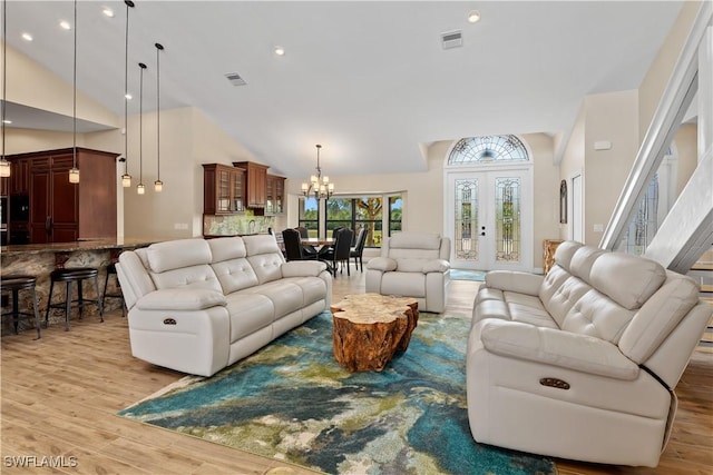 1701 Casey Key Dr, Punta Gorda, FL 33950 - living room with a chandelier, high vaulted ceiling, light wood-type flooring, and recessed lighting