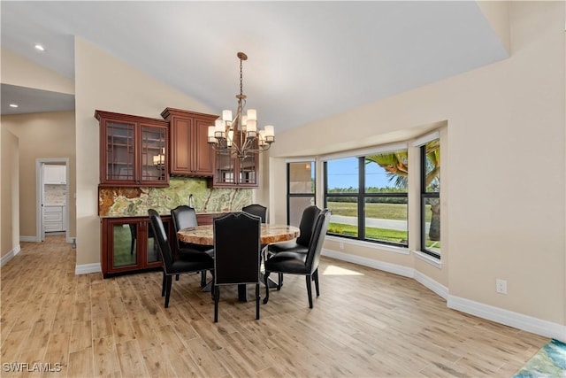 1701 Casey Key Dr, Punta Gorda, FL 33950 - dining room with a chandelier, light wood-style flooring, recessed lighting, and high vaulted ceiling