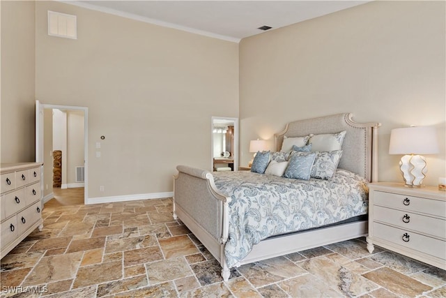 1701 Casey Key Dr, Punta Gorda, FL 33950 - bedroom featuring a towering ceiling, stone tile floors, and ornamental molding