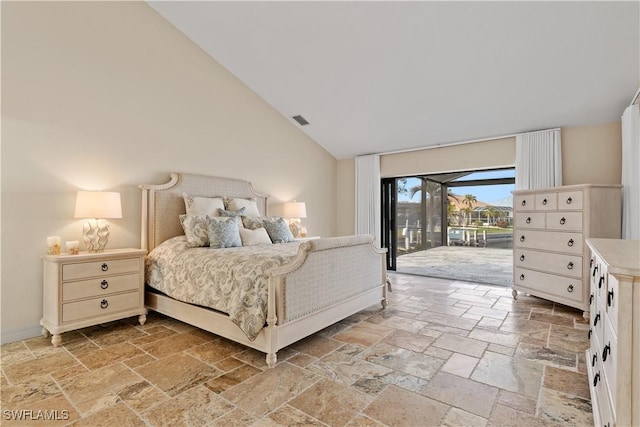 1701 Casey Key Dr, Punta Gorda, FL 33950 - bedroom with stone tile floors, access to outside, and high vaulted ceiling