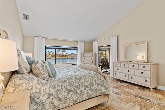 1701 Casey Key Dr, Punta Gorda, FL 33950 - bedroom featuring access to exterior, stone tile floors, high vaulted ceiling, and a water view