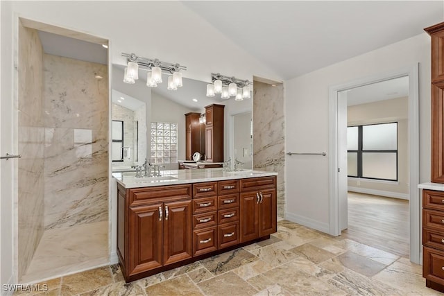 1701 Casey Key Dr, Punta Gorda, FL 33950 - bathroom featuring lofted ceiling, double vanity, a marble finish shower, and stone tile floors