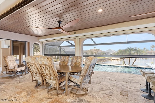 1701 Casey Key Dr, Punta Gorda, FL 33950 - dining space with wooden ceiling, stone finish flooring, ceiling fan, and a sunroom
