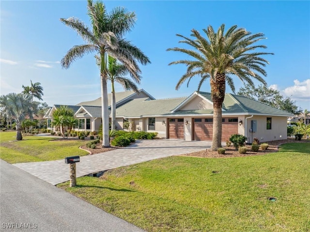 1701 Casey Key Dr, Punta Gorda, FL 33950 - view of front of property with a garage, decorative driveway, a front yard, and a tiled roof