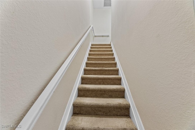 9450 Ivy Brook Run Unit 602, Fort Myers, FL 33913 - staircase with a textured wall