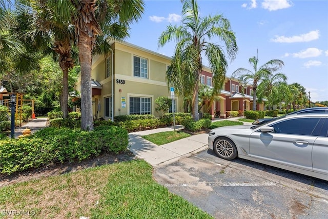 9450 Ivy Brook Run Unit 602, Fort Myers, FL 33913 - view of front of property with uncovered parking and stucco siding