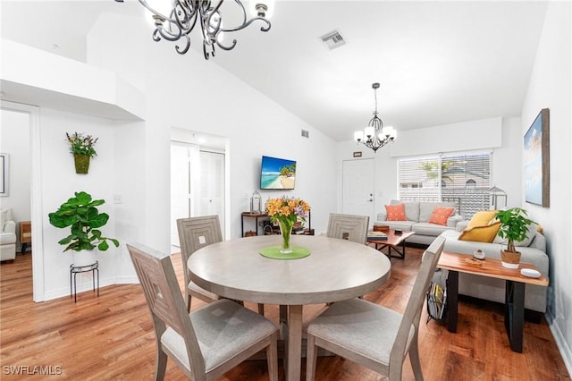 4945 Cougar Ct S Unit 4-202, Naples, FL 34109 - dining space with a chandelier, light wood-style flooring, and high vaulted ceiling