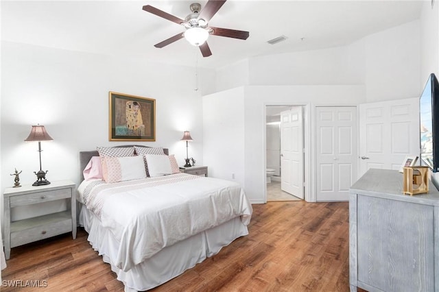 4945 Cougar Ct S Unit 4-202, Naples, FL 34109 - bedroom featuring wood finished floors, connected bathroom, and a ceiling fan