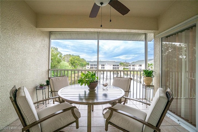 4945 Cougar Ct S Unit 4-202, Naples, FL 34109 - sunroom / solarium with a textured wall, a ceiling fan, and tile patterned floors