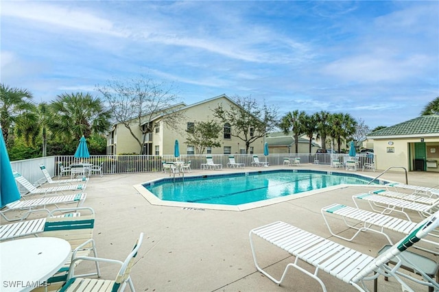4945 Cougar Ct S Unit 4-202, Naples, FL 34109 - community pool featuring a patio