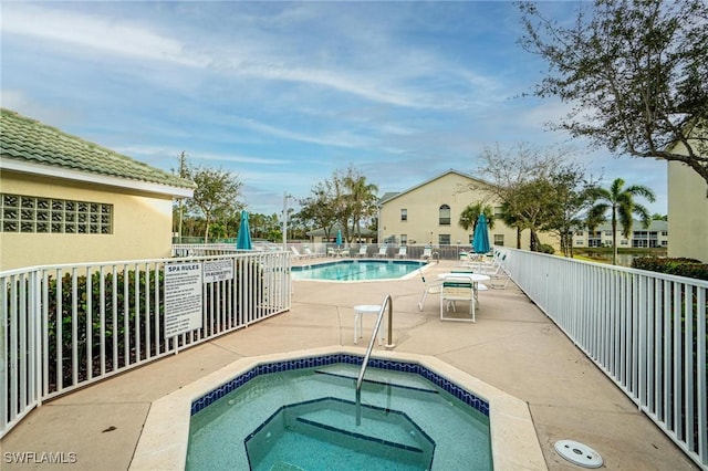 4945 Cougar Ct S Unit 4-202, Naples, FL 34109 - community pool featuring a patio area and a community hot tub