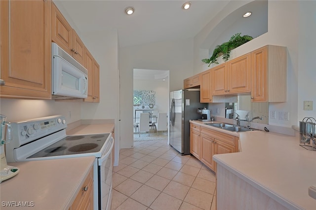 26962 Montego Pointe Ct Unit 202, Bonita Springs, FL 34134 - kitchen with white appliances, light brown cabinets, lofted ceiling, light countertops, and light tile patterned floors