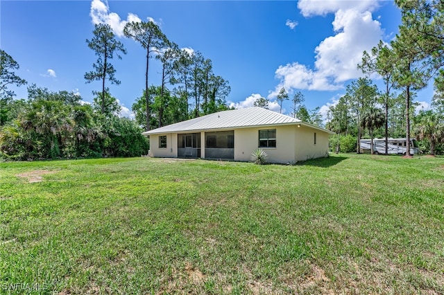 3191 Golden Gate Blvd E, Naples, FL 34120 - back of house featuring a yard, stucco siding, and a metal roof