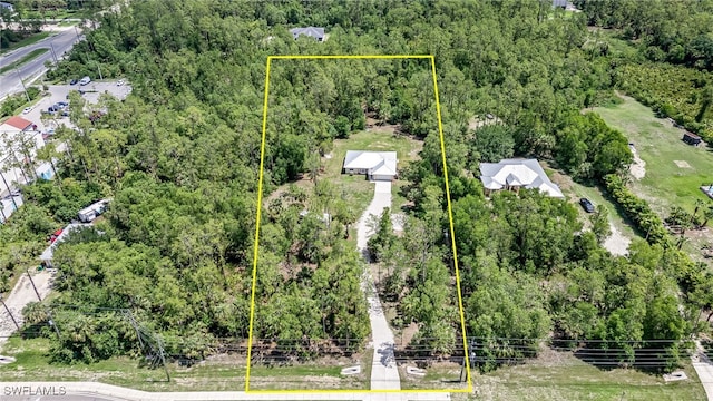 3191 Golden Gate Blvd E, Naples, FL 34120 - aerial overview of property's location with property parcel outlined and a heavily wooded area