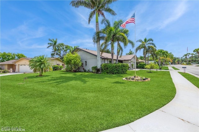 1021 Charlemagne Blvd, Naples, FL 34112 - view of grassy yard with driveway and an attached garage