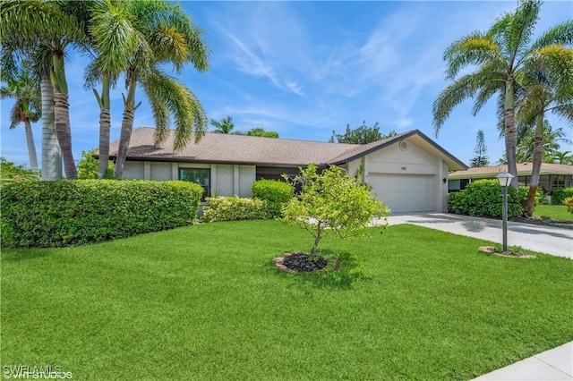 1021 Charlemagne Blvd, Naples, FL 34112 - ranch-style house with concrete driveway, a garage, and a front yard