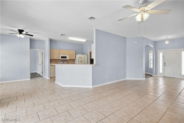 1023 SE 6th St, Cape Coral, FL 33990 - unfurnished living room with ceiling fan, light tile patterned floors, and arched walkways