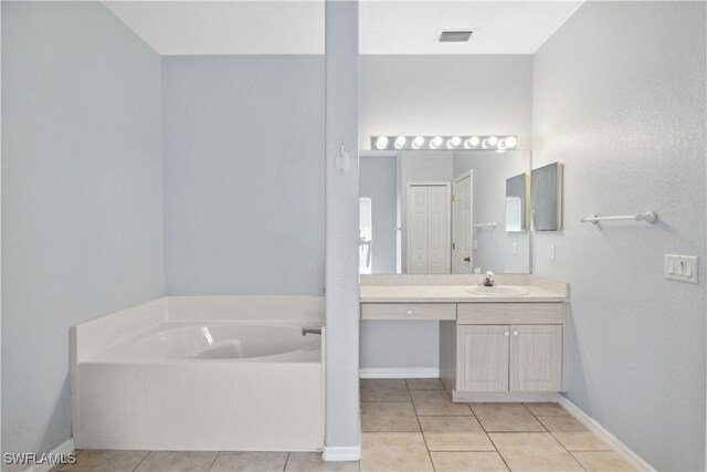 1023 SE 6th St, Cape Coral, FL 33990 - full bathroom with a garden tub, vanity, and tile patterned flooring
