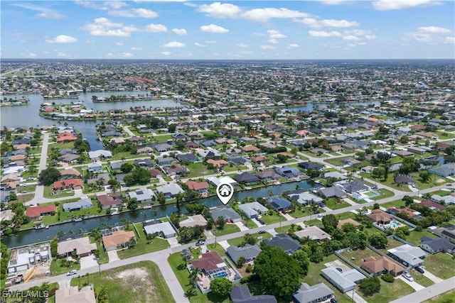 1023 SE 6th St, Cape Coral, FL 33990 - aerial view of property and surrounding area with a large body of water and nearby suburban area